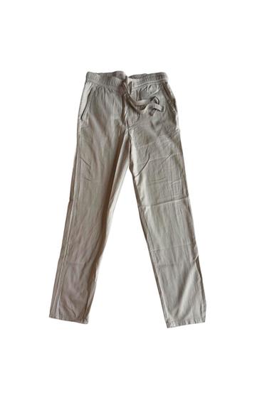Light beige casual long pants with an elastic waist and drawstring,
on a white background.
