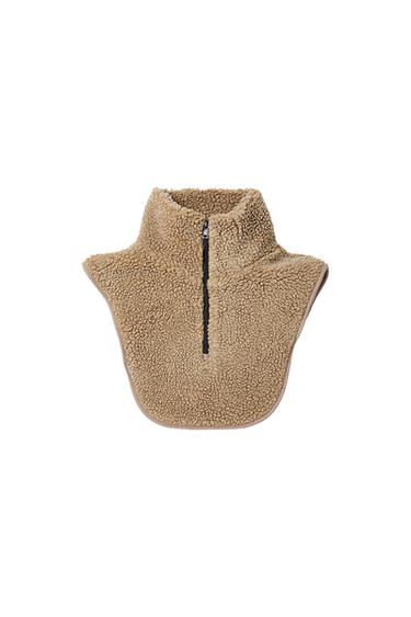 Beige synthetic wool neck with black zip in the centre, on a white background.