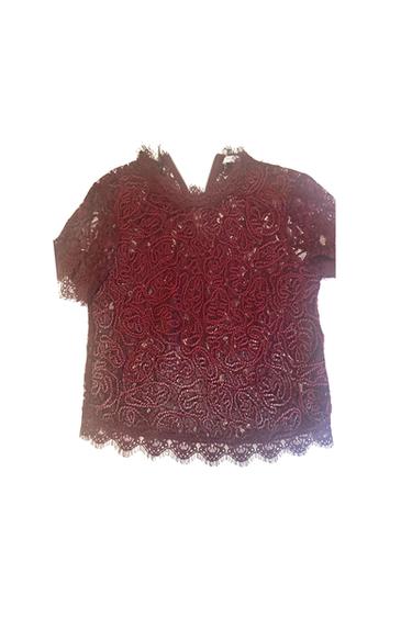 Maroon short-sleeved lace top with a floral design, high neck and scalloped edges, on a white background.