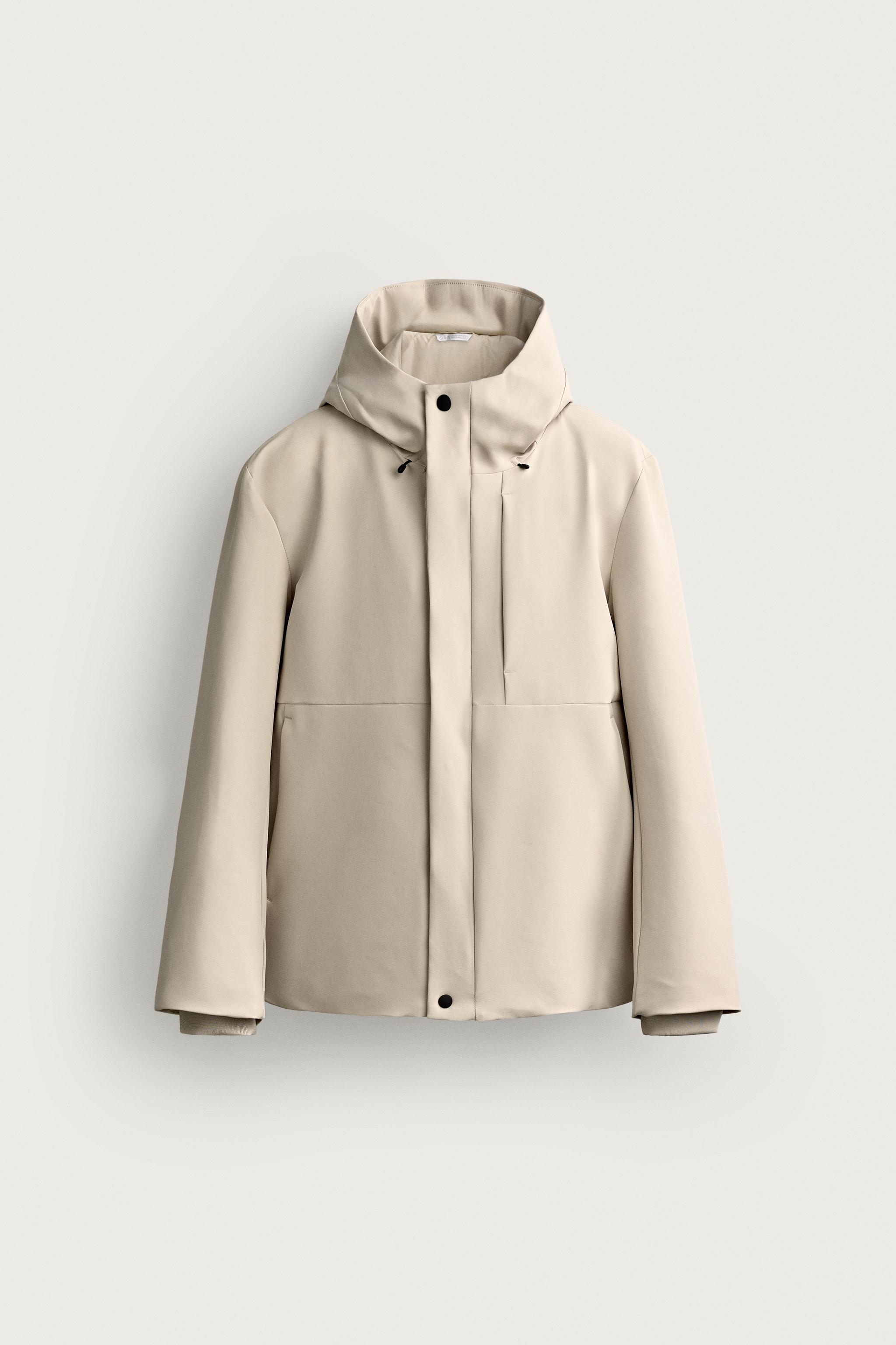 BLOUSON TECHNIQUE À CAPUCHE DÉPERLANT