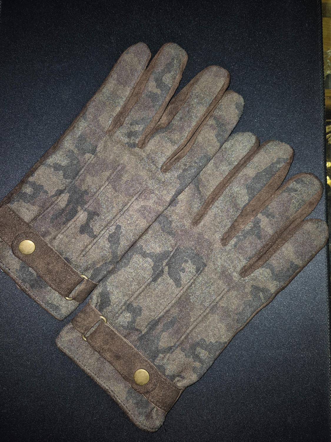 Brown camouflage gloves with gold button details on a black background.