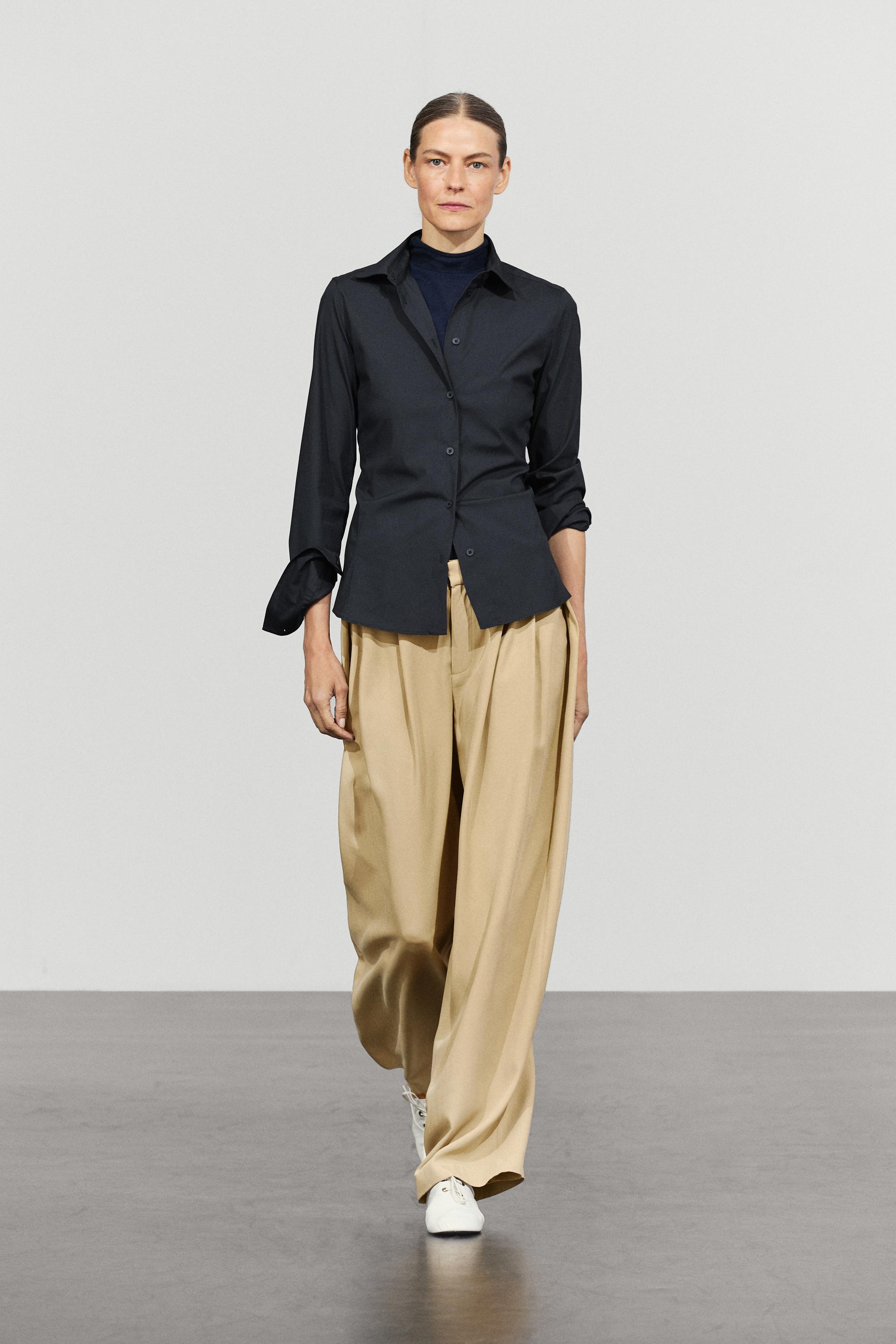 Flowing pleated pants with button detail — Beige