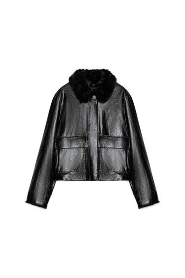 Front view of a black faux leather jacket with a fur lapel collar, long sleeves, and patch pockets with flaps.