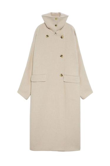Long beige coat with a high collar and large buttons. Minimalist and elegant design, presented on a white background.