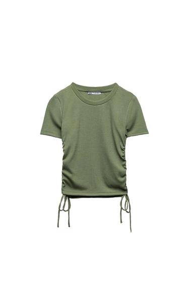 Green short-sleeved ribbed T-shirt. Featuring side ruching and adjustable drawstrings at the hem. White background.