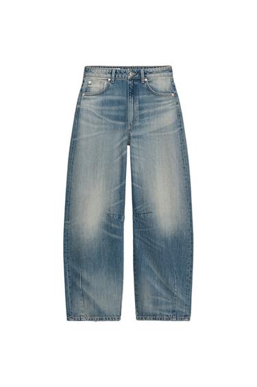 Front view of light blue wide leg jeans with distressed effect and front and back pockets.