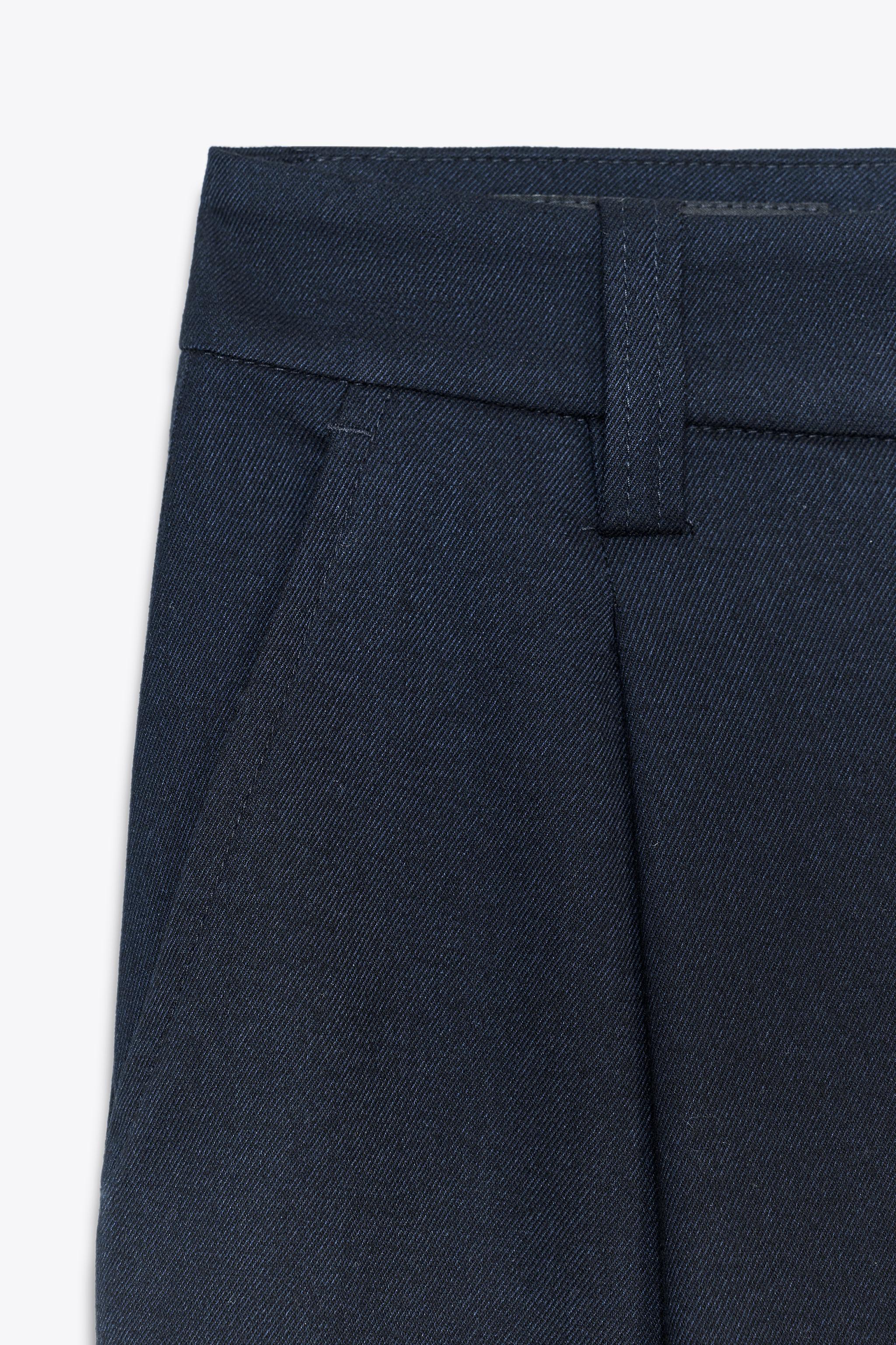 PANTALON À PINCES BAS BOUTON