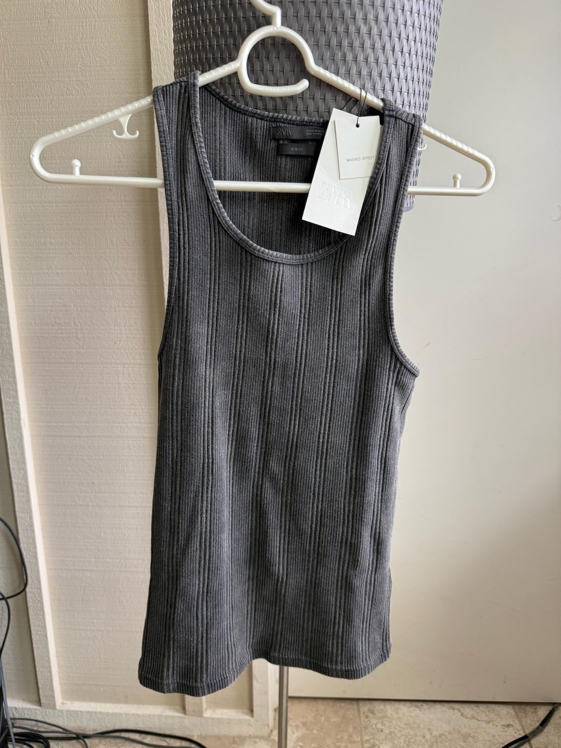 Dark grey ribbed vest top on a white hanger. Labels with text: ZARA, SLIM FIT, WASHED EFFECT.
