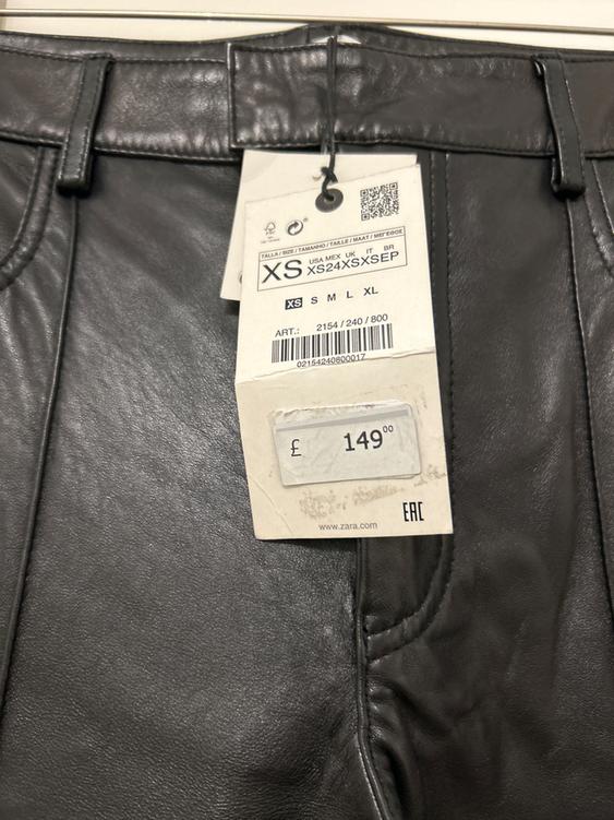 Black leather trousers with a £149 price tag. Sizes XS to XL visible. Item code: 2154/240/800. Zara brand.