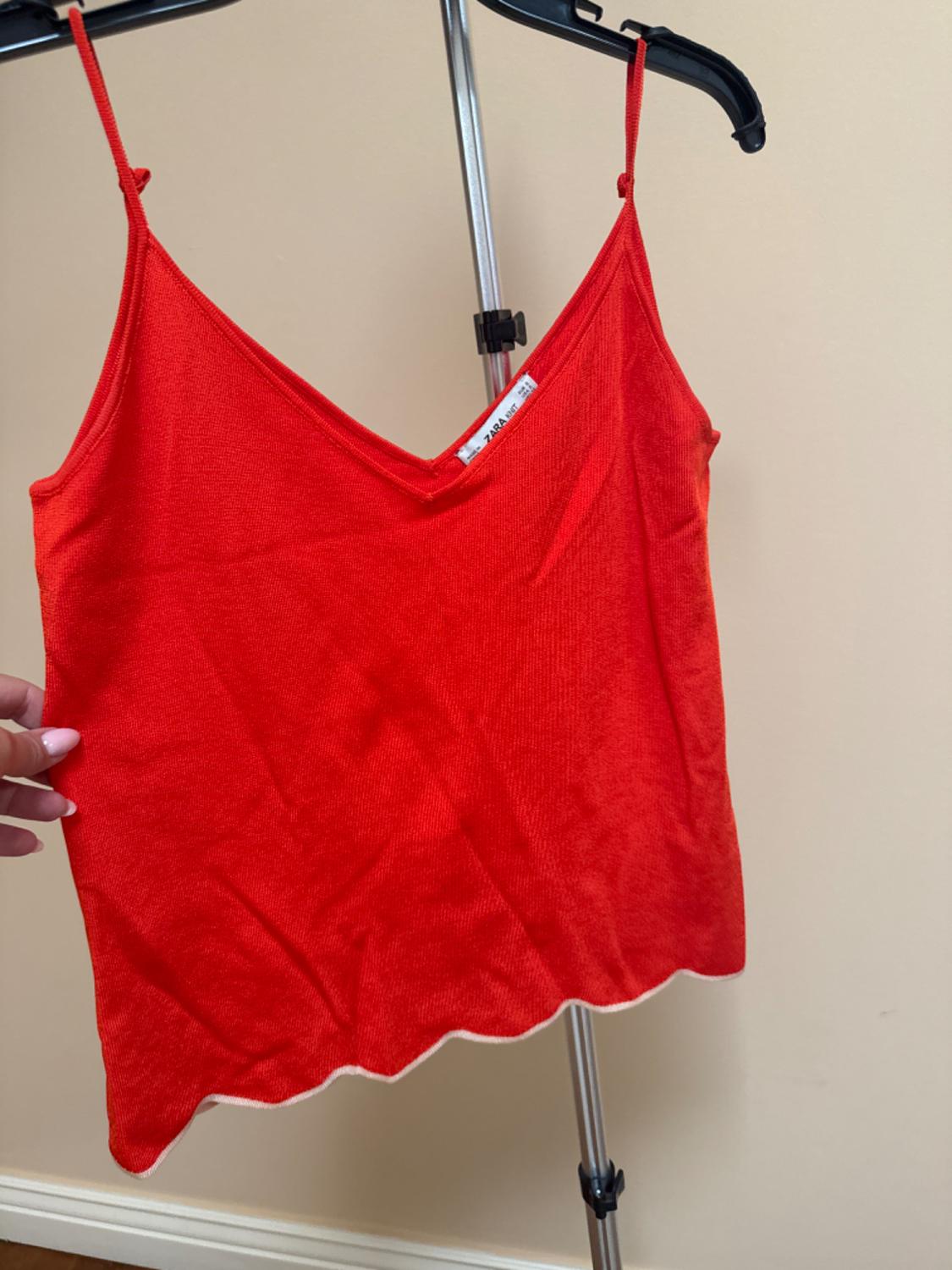 Front view of red camisole top with V-neck.