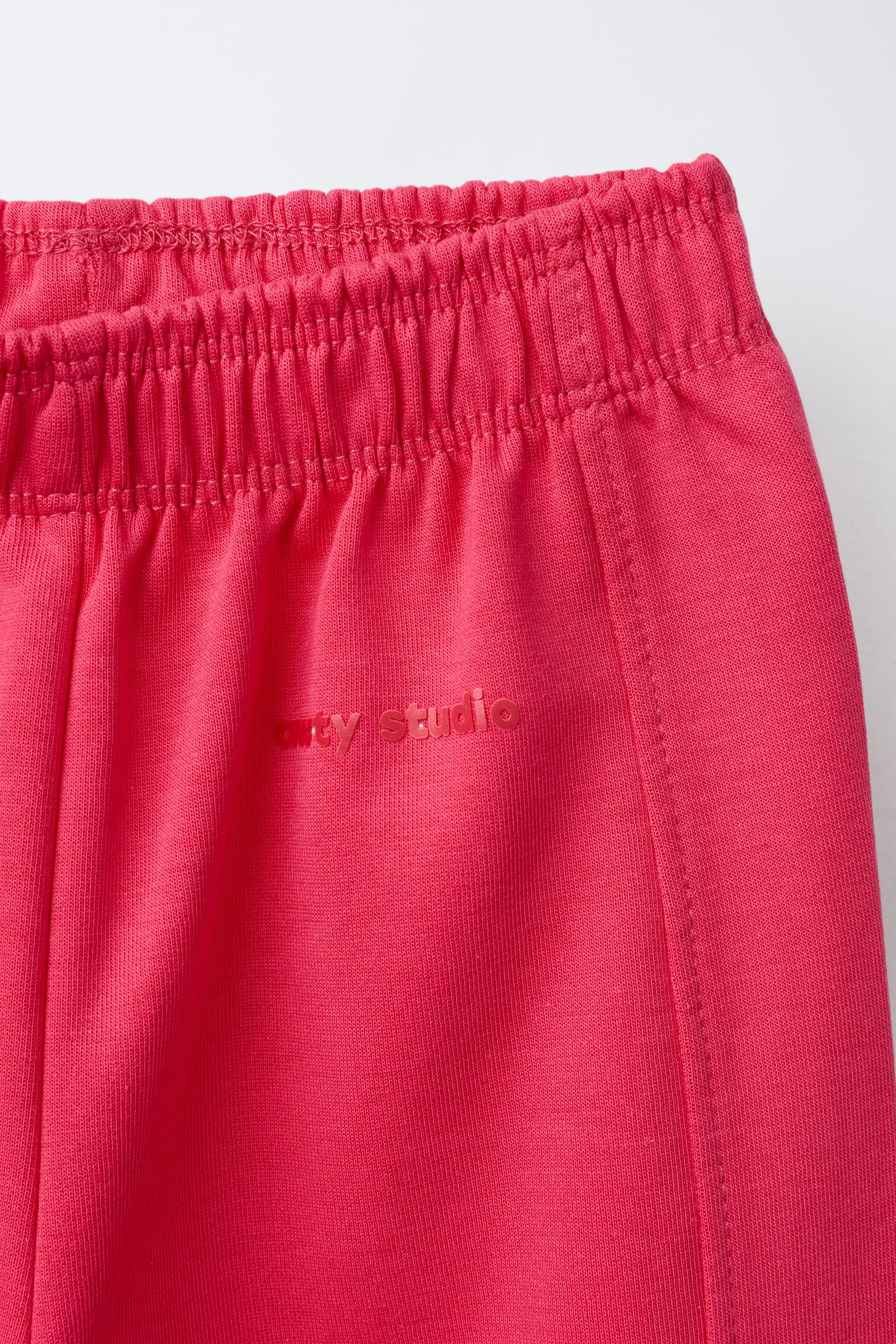 WIDE LEG INTERLOCK RAISED TEXT PANTS
