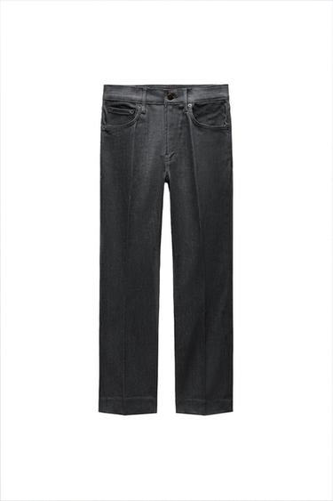 Front view of black trousers with front pockets and button fastening.