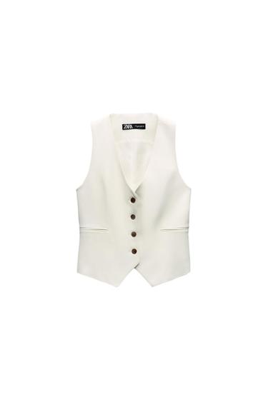 Front view of a white vest with dark buttons and side pockets.