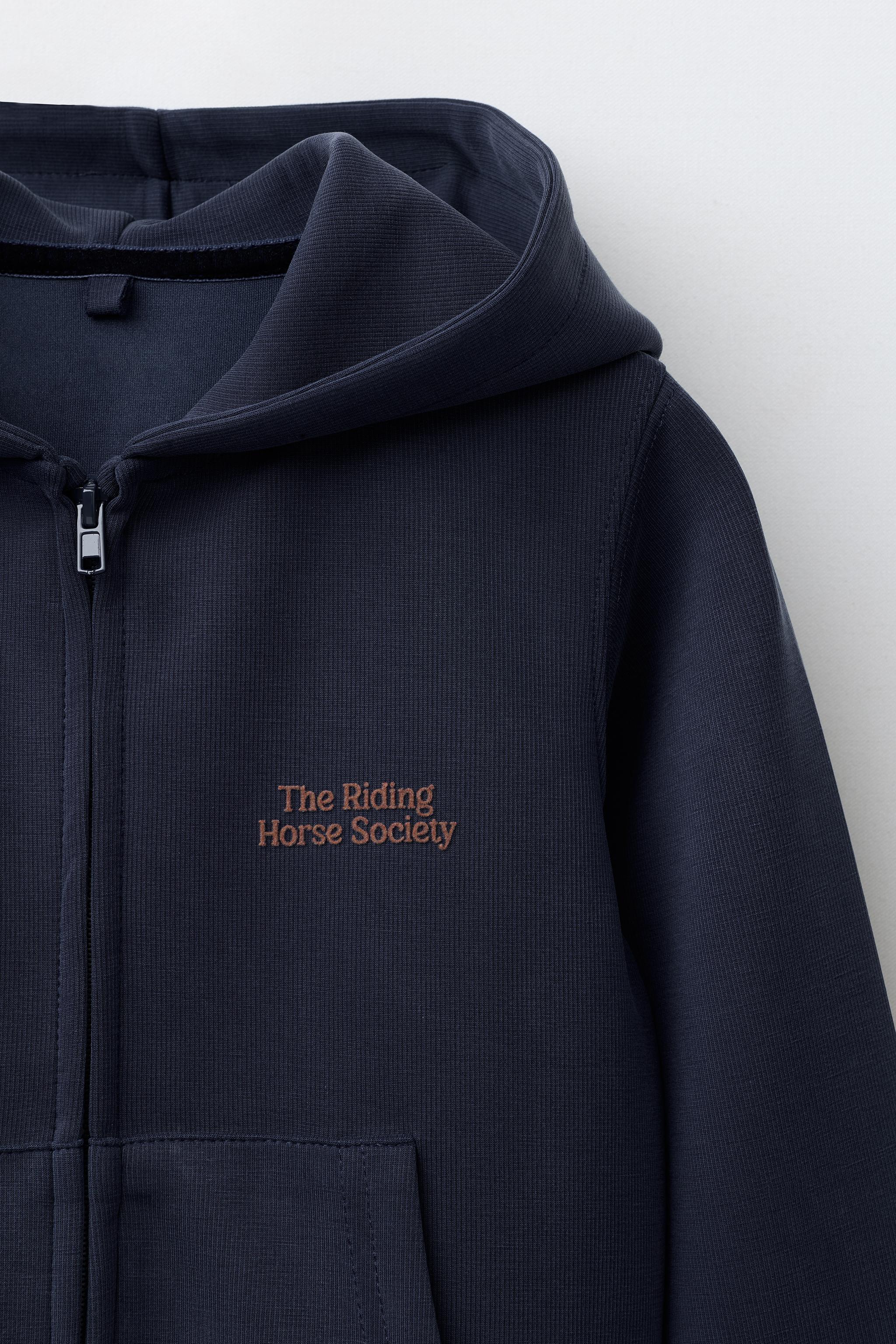 RAISED TEXT HOODED SWEATSHIRT