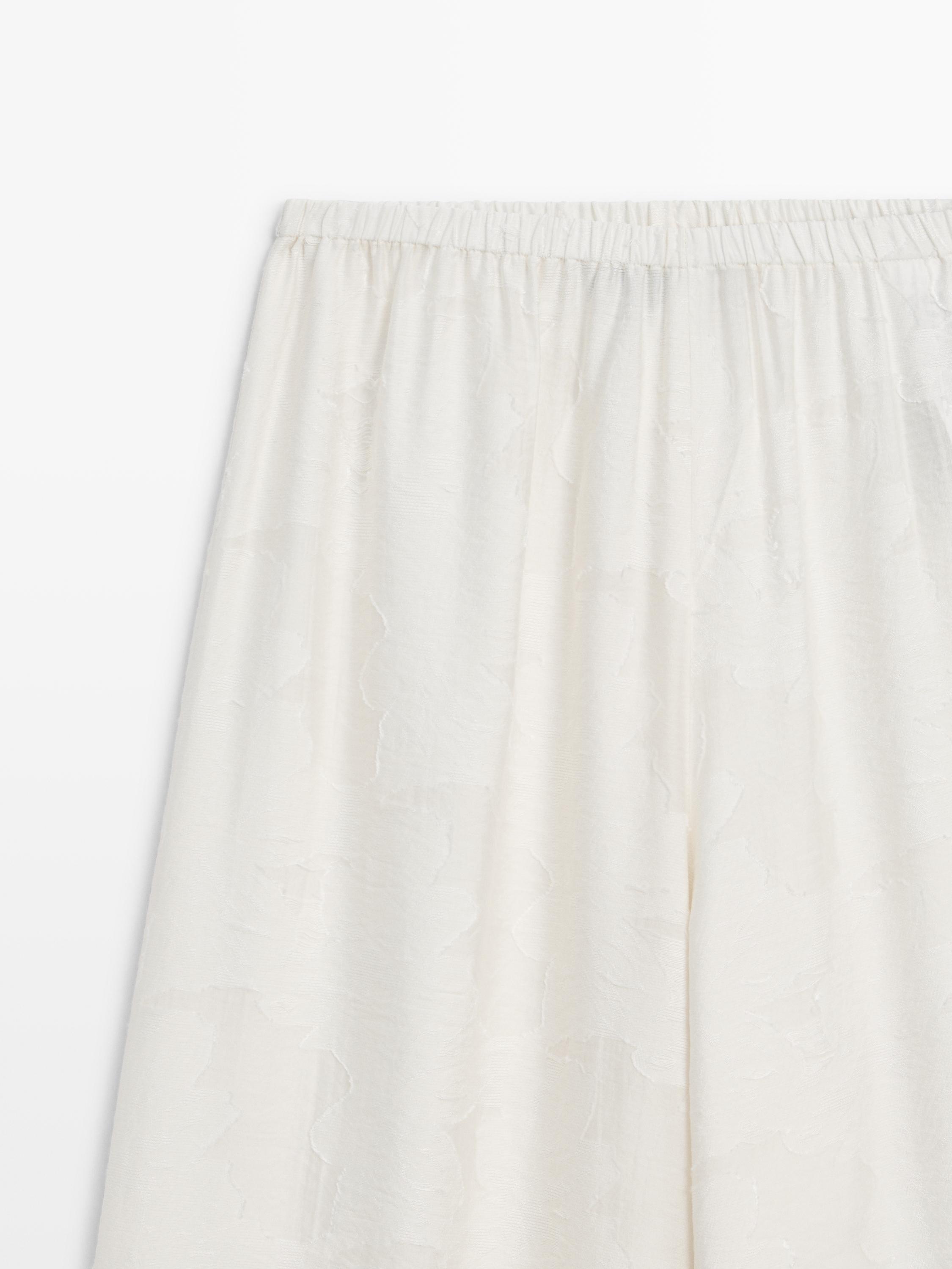 Flowing stretch trousers with fabric detail