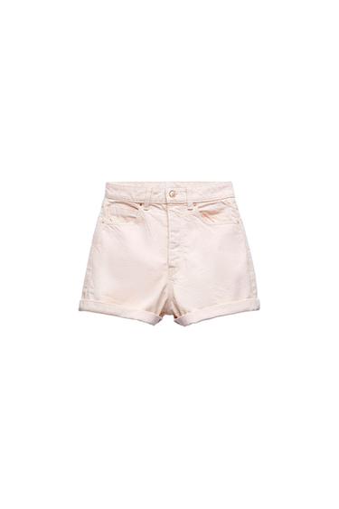 Front view of beige shorts with front pockets and hem.