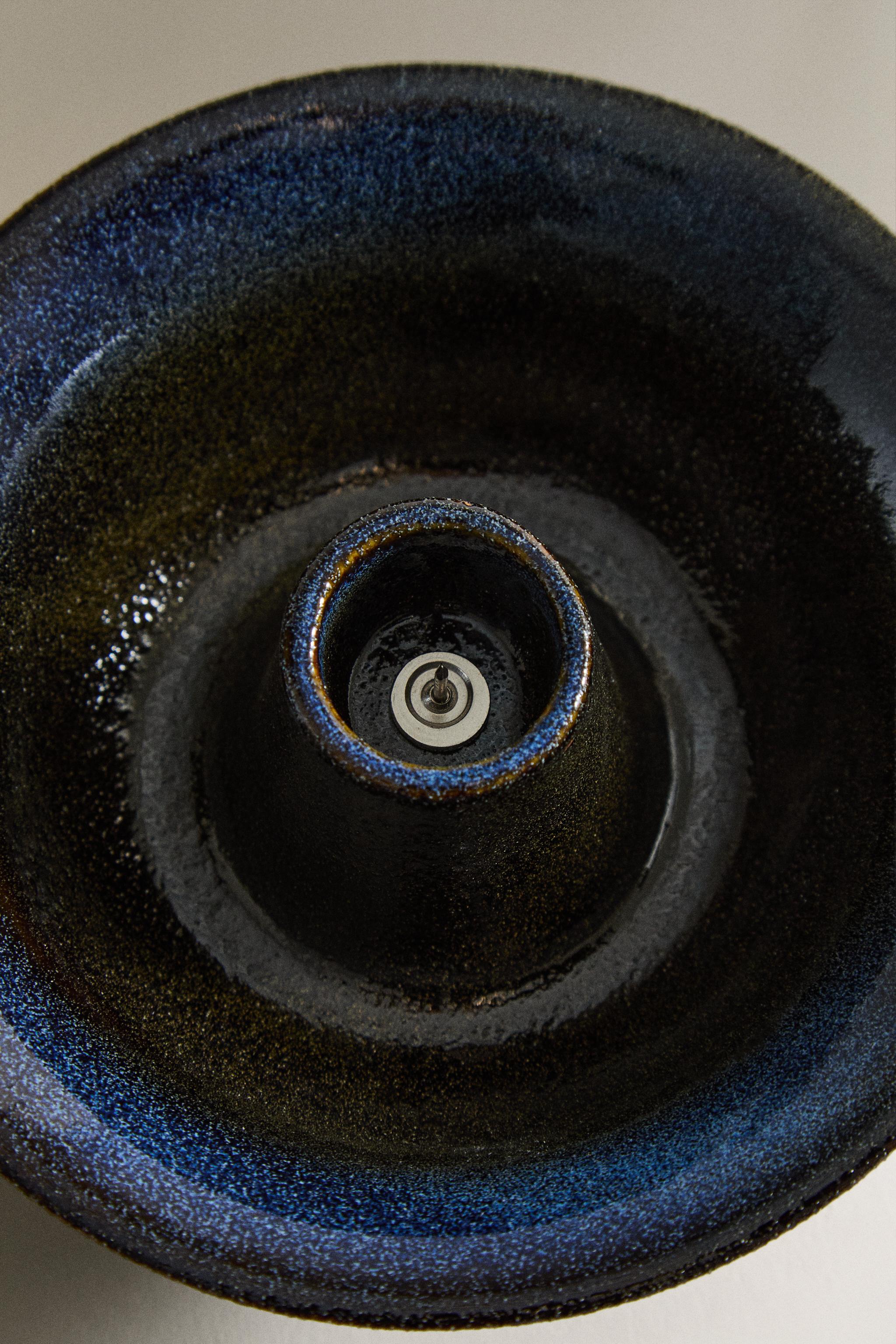 IRON AND STONEWARE CANDLEHOLDER