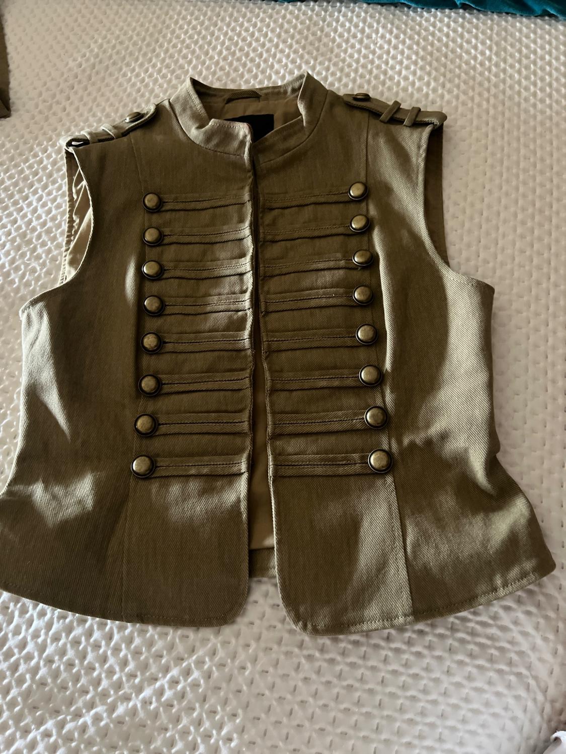 Olive green military-style waistcoat with a high neck, epaulettes and front buttons, on a textured white surface.