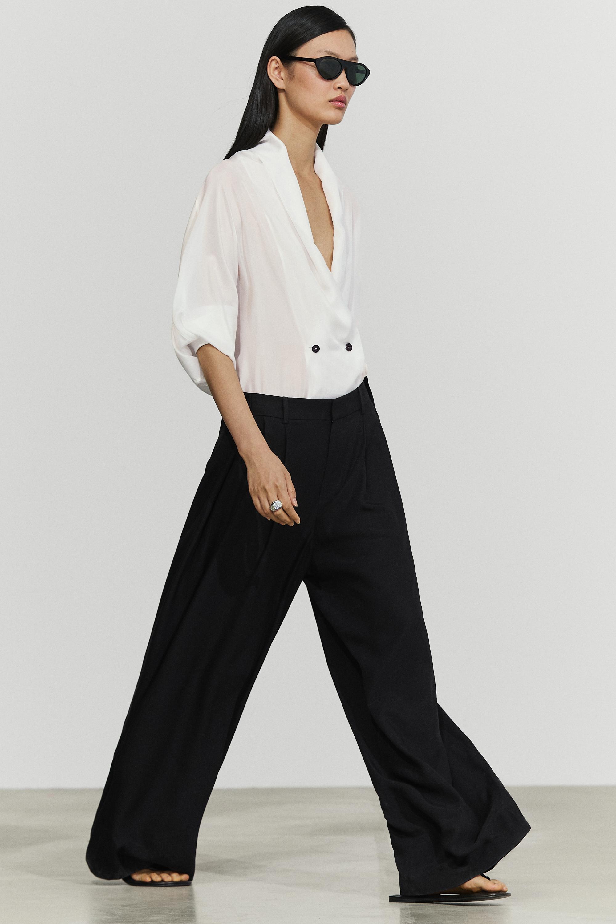 Flowing pleated pants with button detail — Black