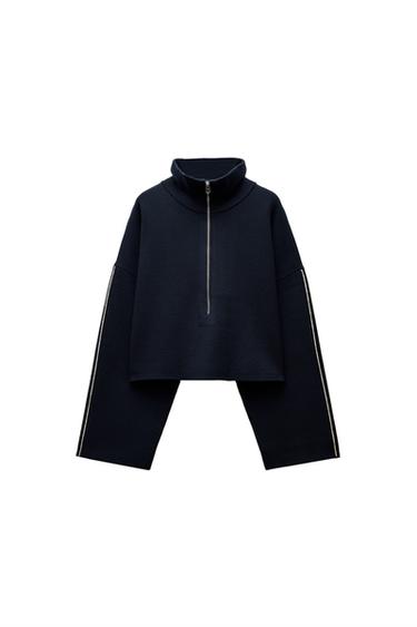 Front view of a navy blue zip-up sweatshirt with a high neck.