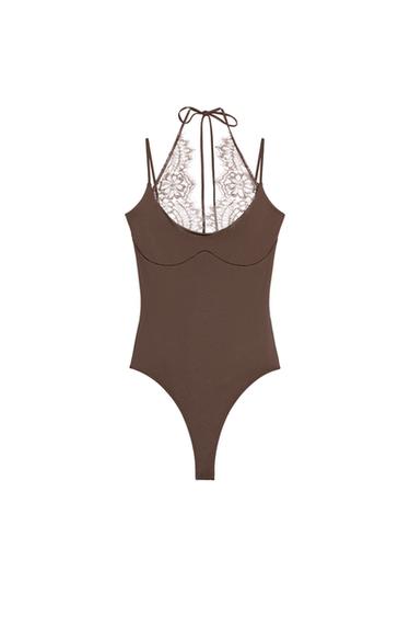 Front view of a chocolate bodysuit with a halter neck, thin straps, and a lace detail on the back with a tie.