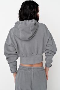 Sweatshirt with adjustable drawstring hood. Long sleeves with