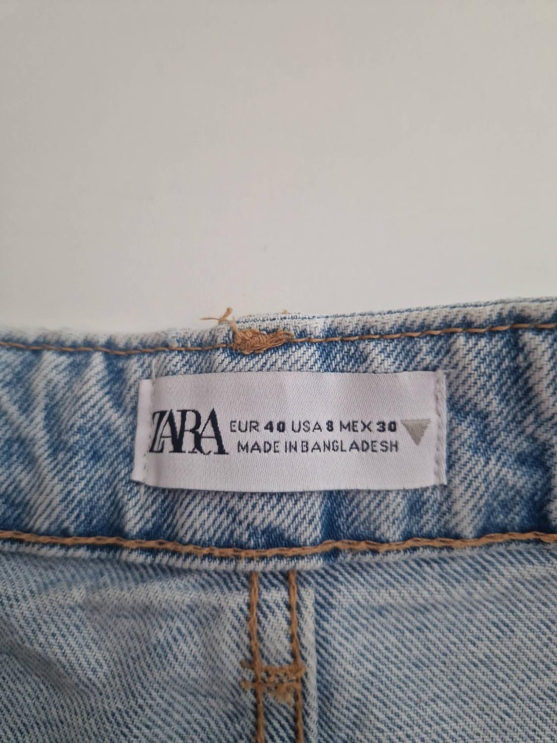 Detail of the inner label on light blue jeans with the text: ZARA EUR 40 USA 8 MEX 30 MADE IN BANGLADESH.
