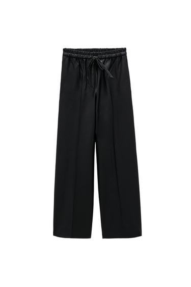 WAXED-EFFECT TROUSERS