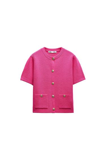 Pink short-sleeved knit cardigan, with gold buttons and two front pockets on a white background. ZARA label.