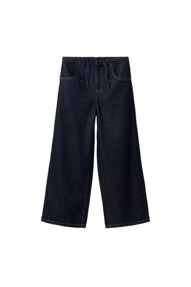Front view of ink blue wide leg jeans with elasticated waistband, adjustable drawstrings and front and back pockets.