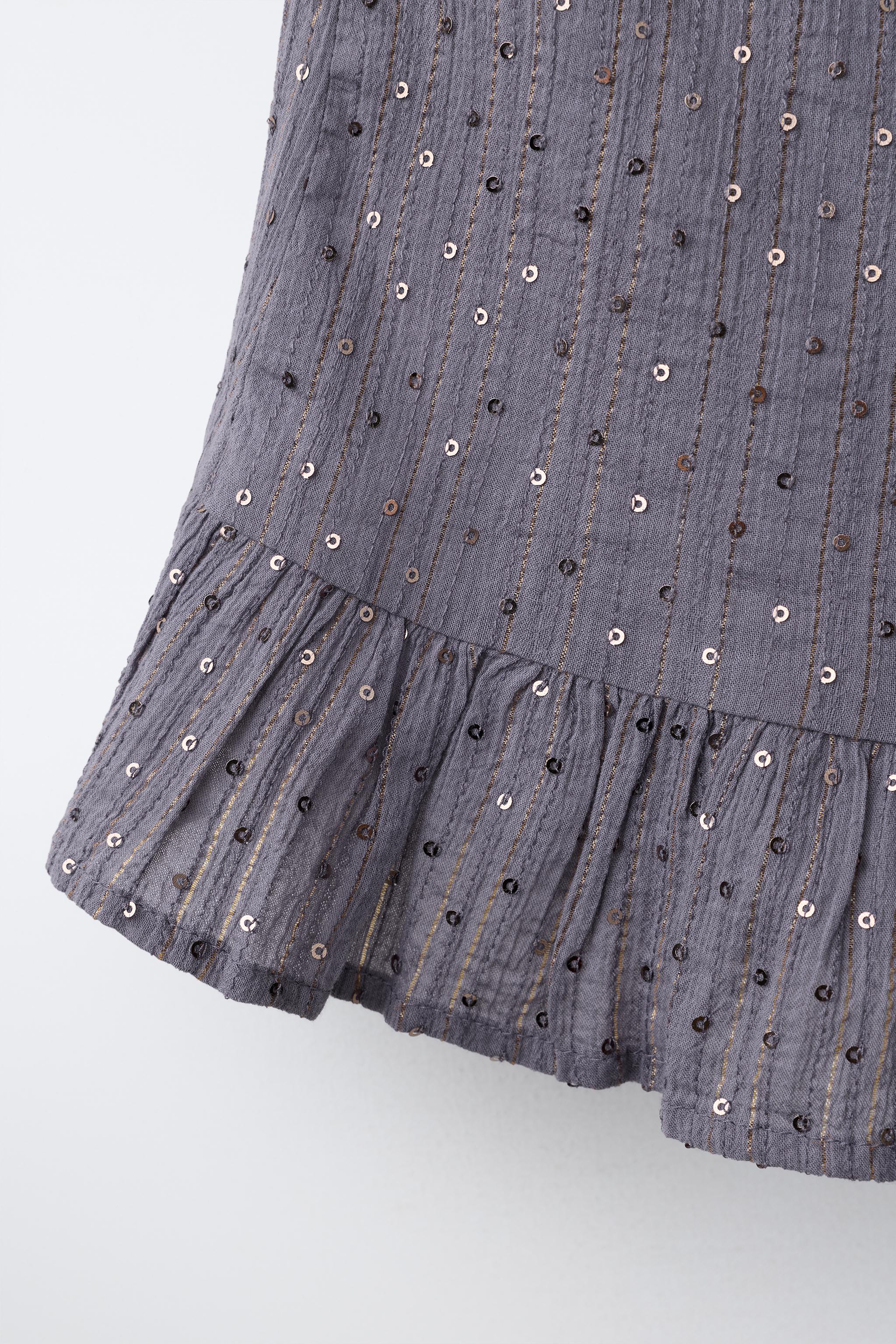JUPE DRAPÉE À PAILLETTES