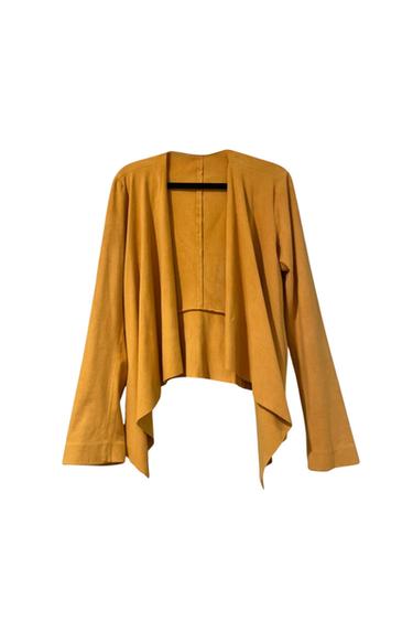 Front view of an open mustard-colored jacket with long sleeves and an asymmetrical design.