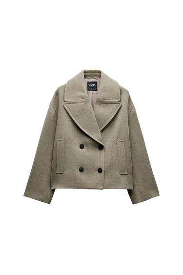 Front view of a gray jacket with large lapels, black buttons, and front pockets.