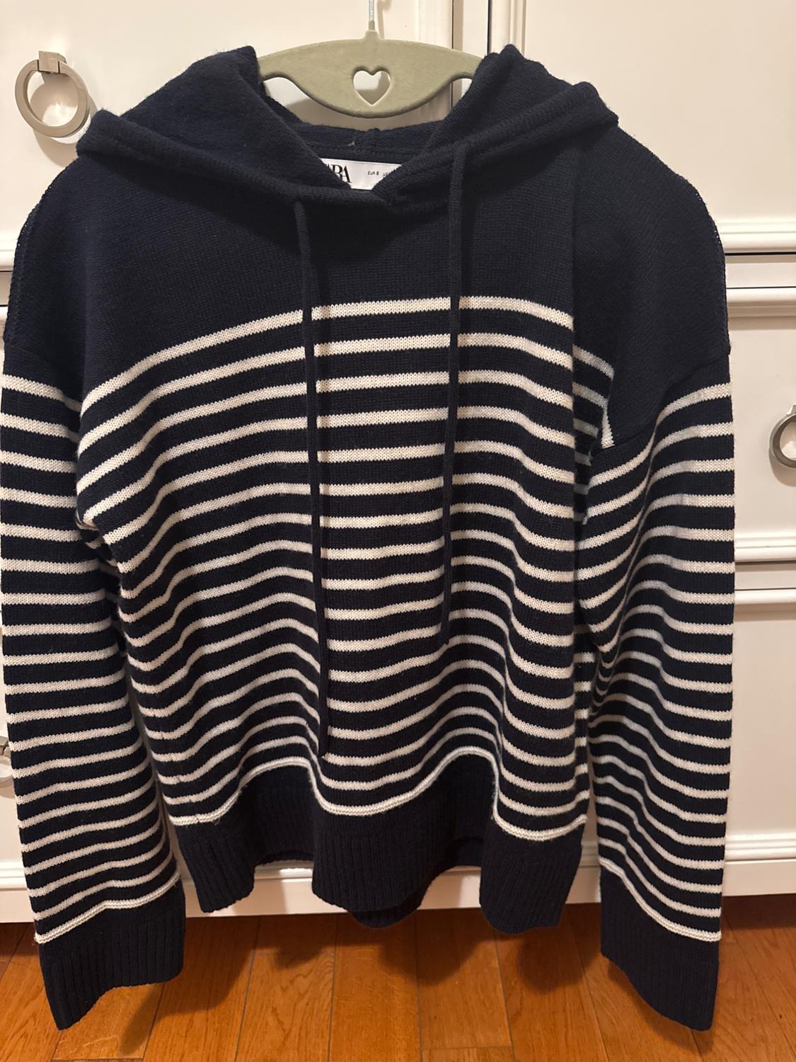 Front view of a black and white striped hoodie.
