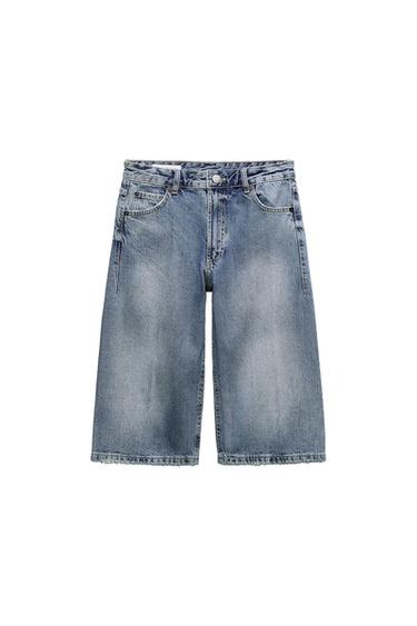 Blue denim shorts with a washed effect and frayed hem on a white background.