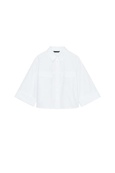 Front view of a white shirt with three-quarter sleeves and front pockets.