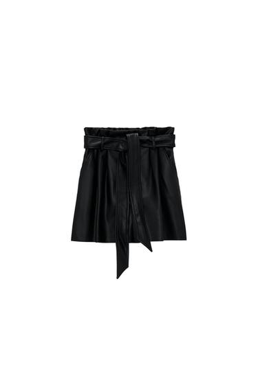 Black mini skirt with front tie belt, pleated design, and shirred waist. White background.