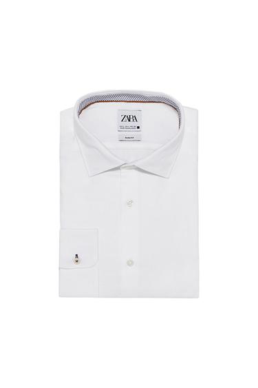 Front view of a white dress shirt with a classic collar and buttoned cuff.