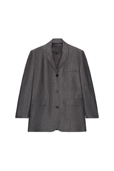 Front view of a straight grey blazer with lapels, long sleeves, button fastening, and flap and jetted pockets on the chest.