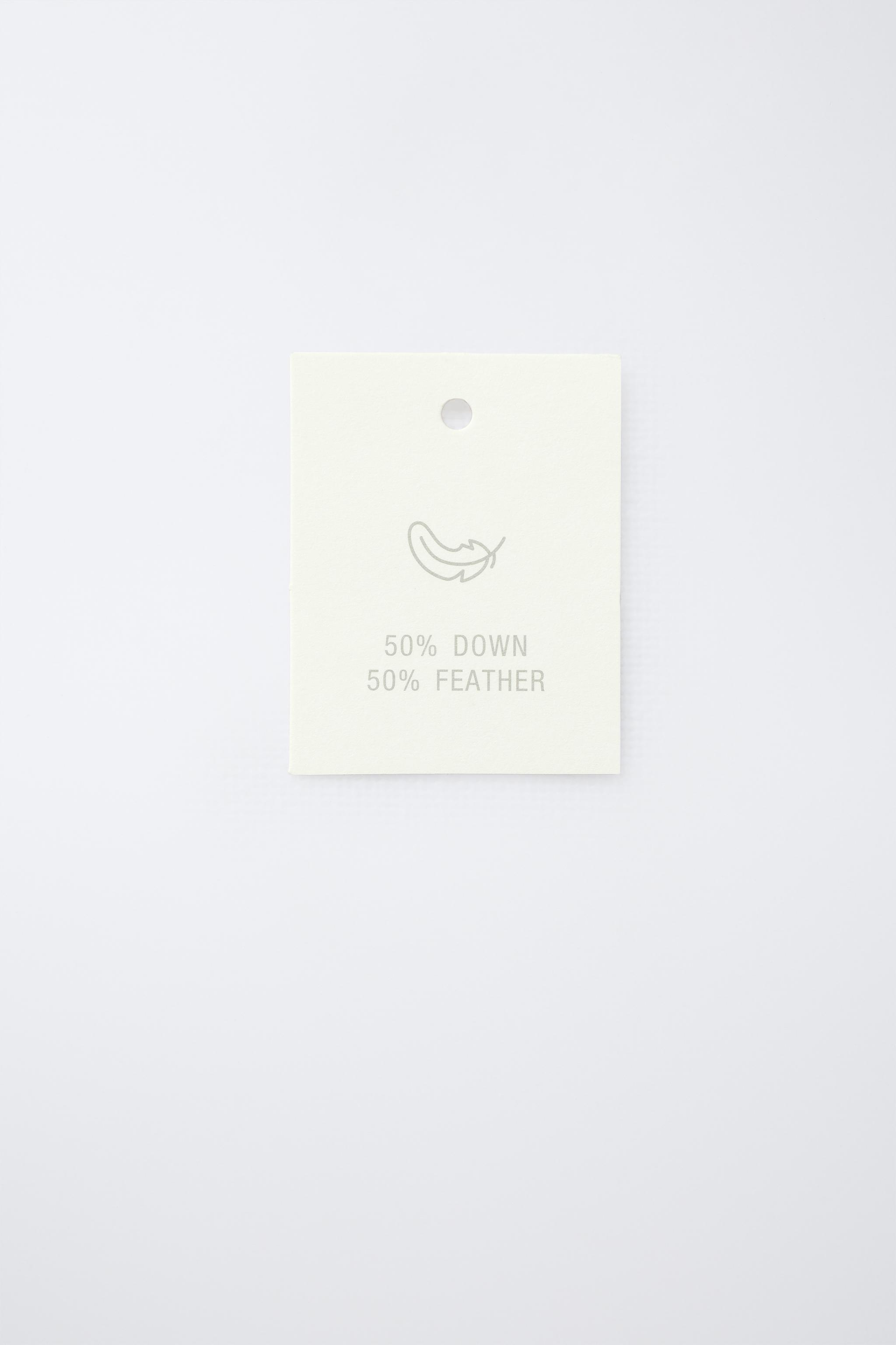 DOUDOUNE EN PLUME ET DUVET DÉPERLANTE AVEC ÉTIQUETTE