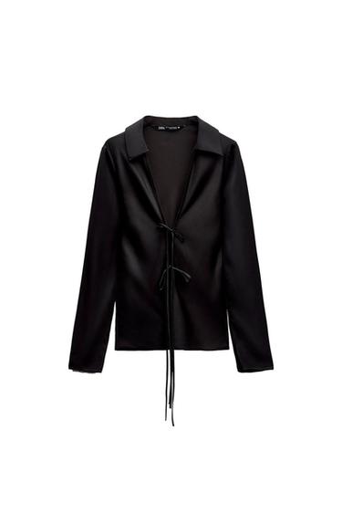 Front view of a black blouse with a front tie and classic collar.