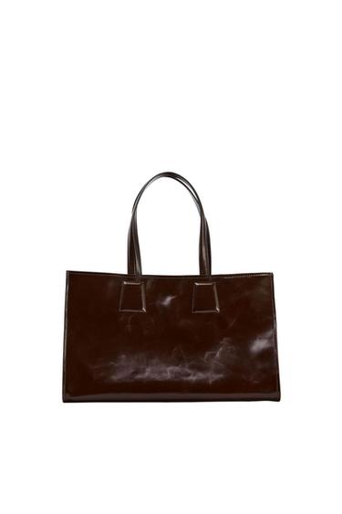 Dark brown rectangular handbag with a glossy finish and crinkled texture. Features two top handles against a white background.