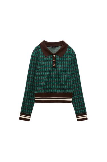 Polo with lapel collar and long sleeves. Rib trim. Front button closure.