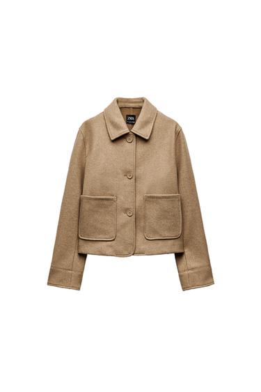 Front view of beige jacket with lapels and front pockets.