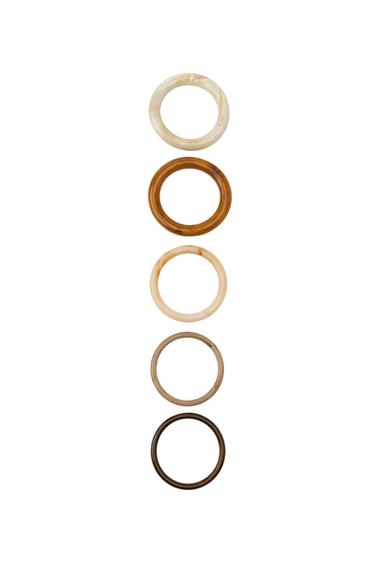 Front view of a five-pack of rigid bracelets in various shades of brown and beige, some with a marbled effect.