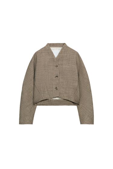 Front view of a toasted short jacket with a V-neck, long sleeves, button fastening, and pleats at the bottom.