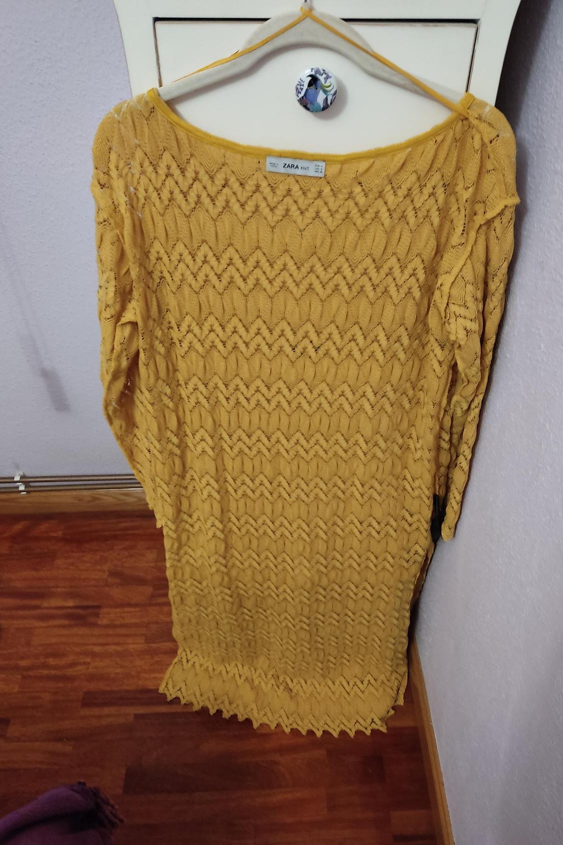 Front view of a yellow dress with a zigzag pattern and a round neck.