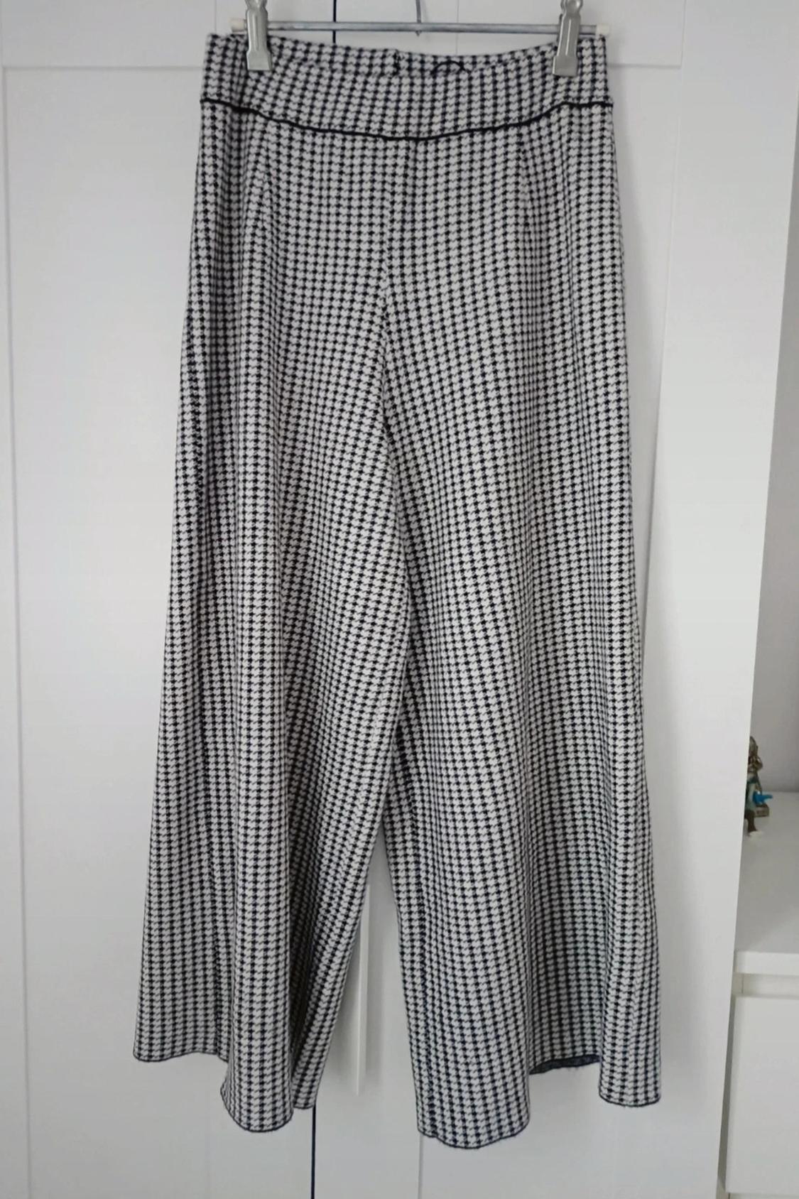 Front view of wide-leg trousers with a black and white checked print.