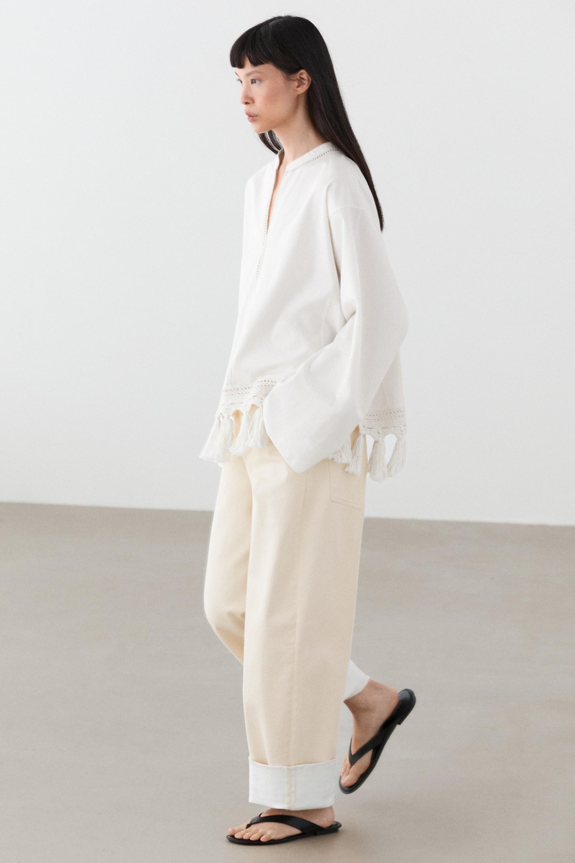 Embroidered blouse with fringed hem