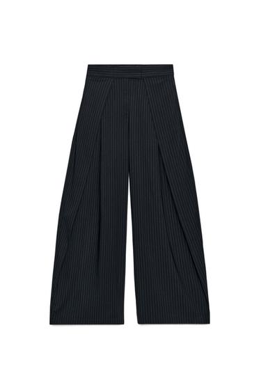 Front view of pinstripe trousers, mid-rise, wide leg, front pleats, side pockets, zip fastening.